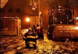 Firefighters waist deep in floodwaters